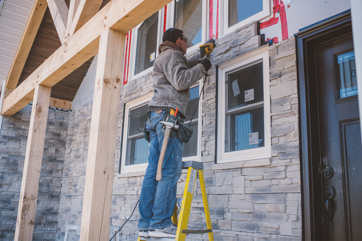 Man Installing Stone Veneer Siding On Wichita Ks Home