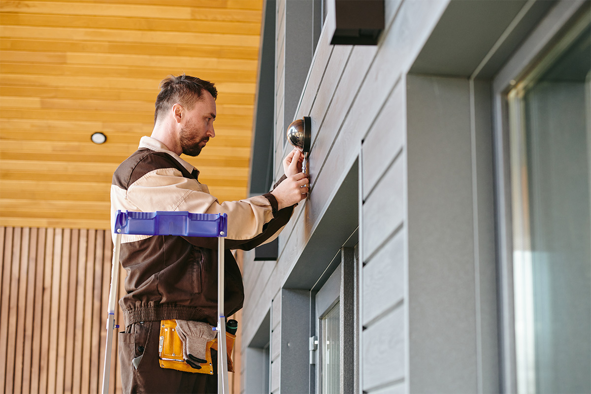 Man Cleaning Siding